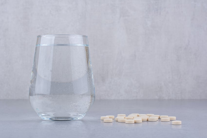 Pharmaceutical-medicine-pills-and-glass-of-water-high-quality-photo.jpg