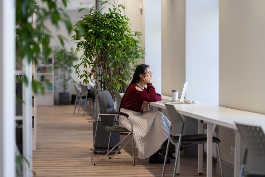 Young-asian-woman-working-remotely-in-modern-public-library-japanese-female-student-studying-online.jpg