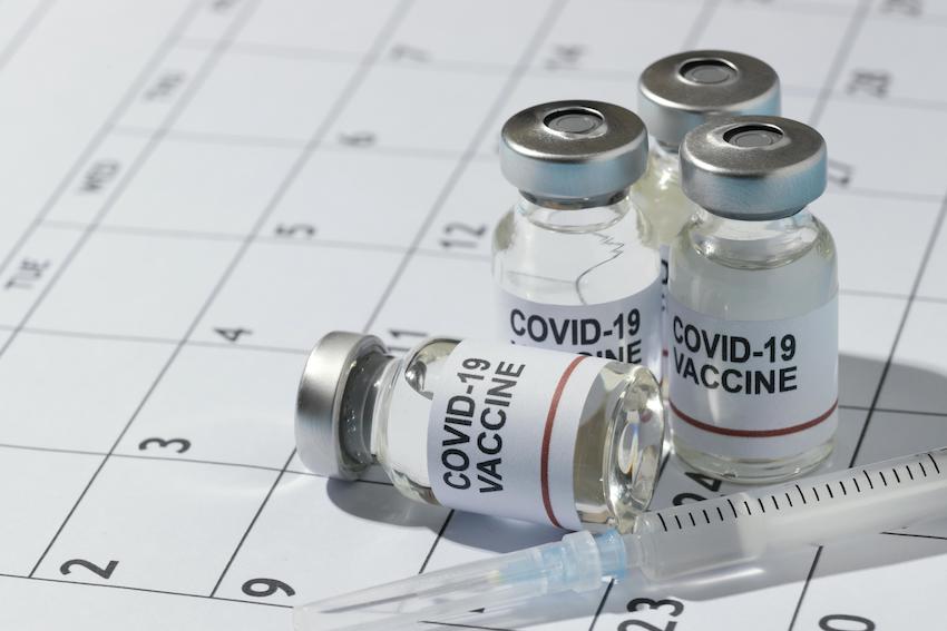 Minimal-vaccine-bottles-composition-on-calendar.jpg