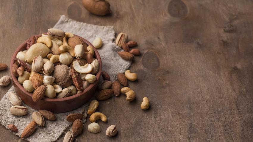 Bowl-with-nuts-copy-space-wooden-background.jpg