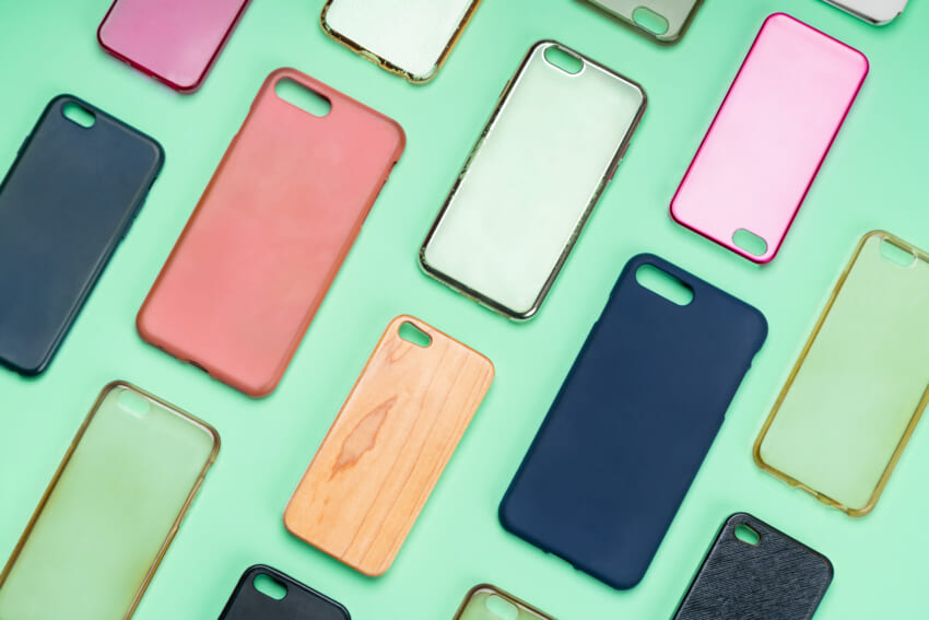 Pile-of-multicolored-plastic-back-covers-for-mobile-phone-choice-of-smart-phone-protector-accessories-on-green-background-a-lot-of-silicone-phone-backs-or-skins-next-to-each-other.jpg