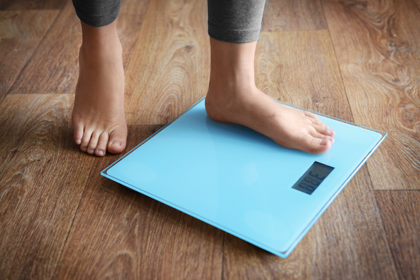Female-bare-feet-standing-on-a-scales.jpg