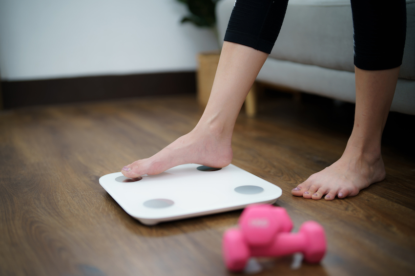 Fat-diet-and-scale-feet-standing-on-electronic-scales-for-weight-control-measurement-instrument-in-kilogram-for-a-diet-control.jpg