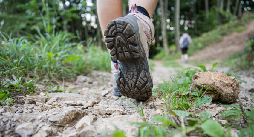Low-angle-view-female-foot-walking-mountain-trail.jpg