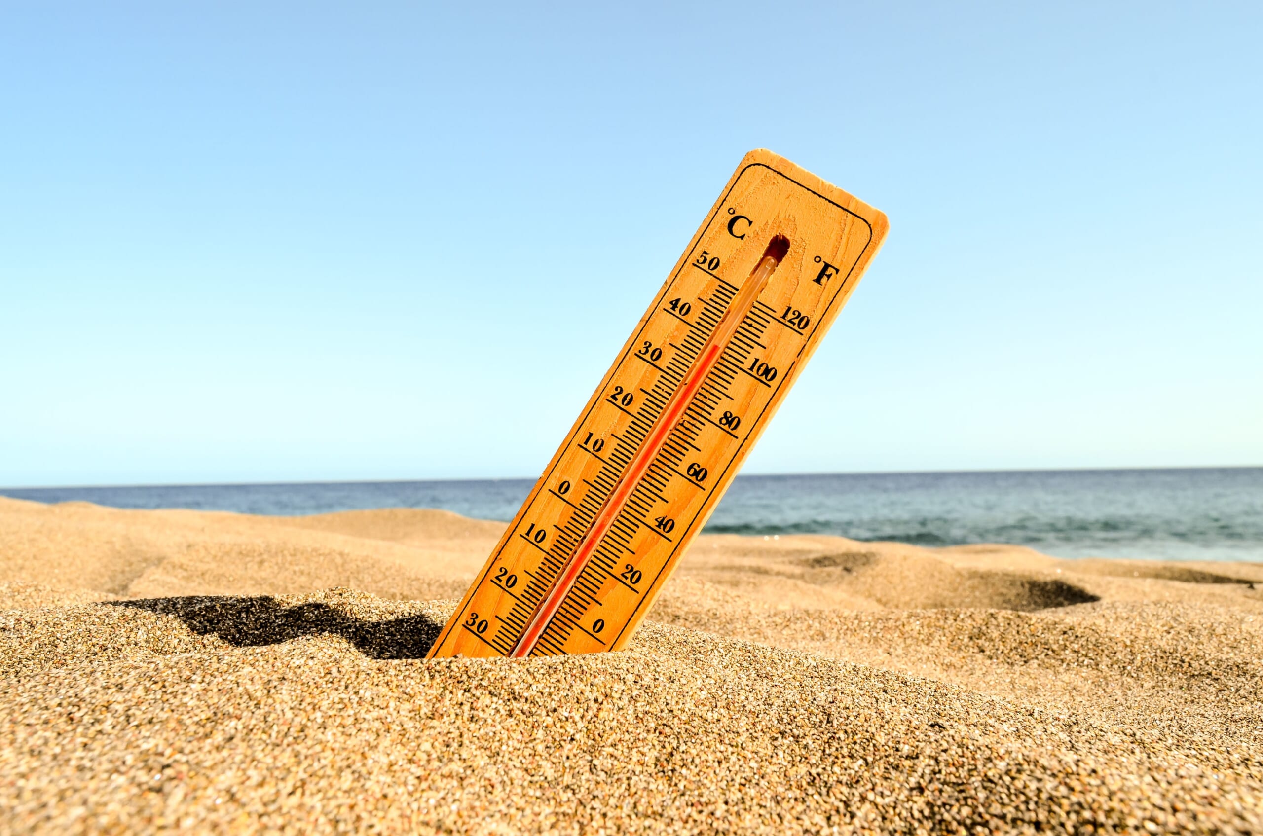 Closeup-shot-thermometer-beach-sand-1.jpg
