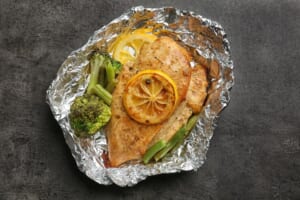 Delicious-chicken-fillet-with-sliced-lemon-vegetables-foil-table_392895-571501.jpg